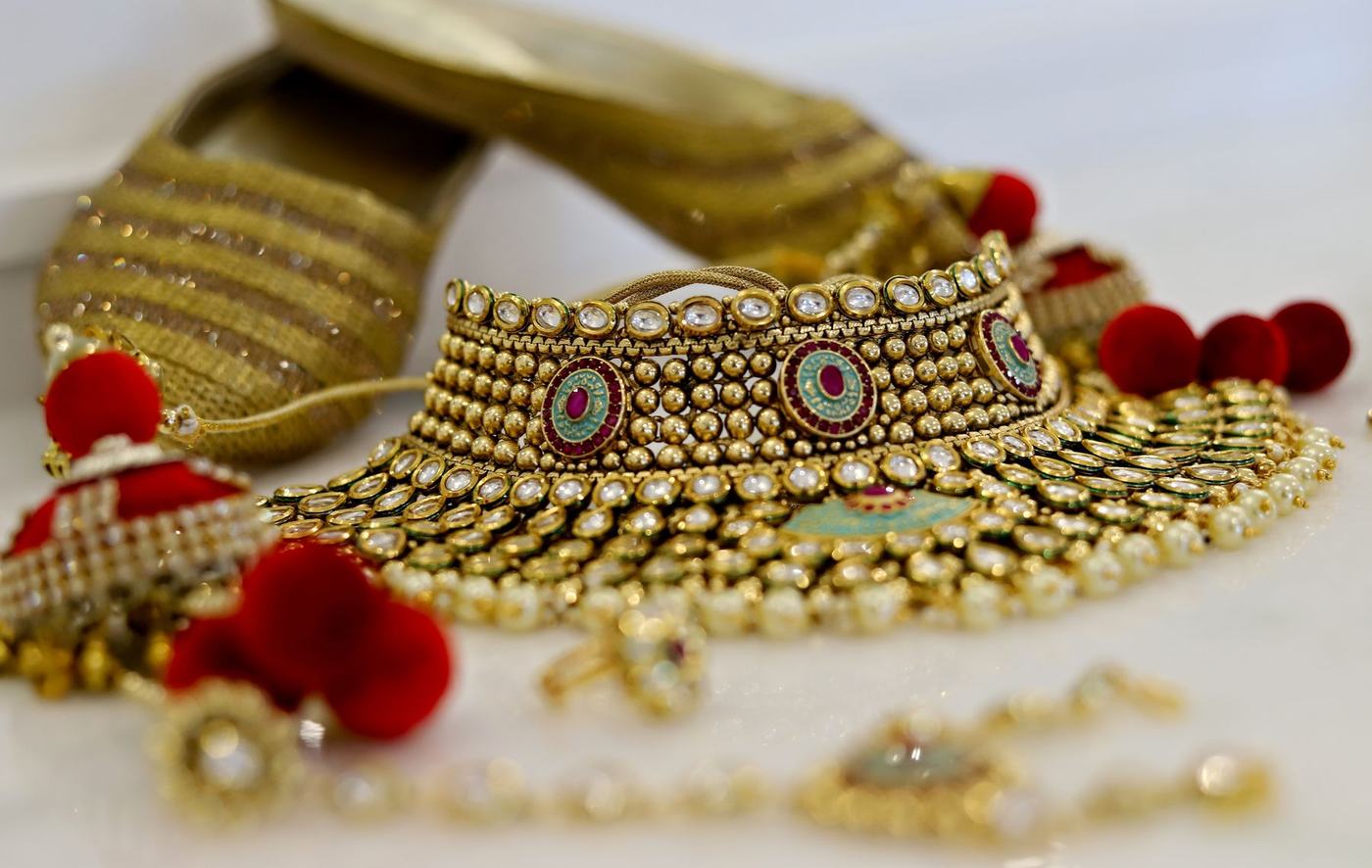 Bridal kundan choker and jhumkas laid out with their red tassels
