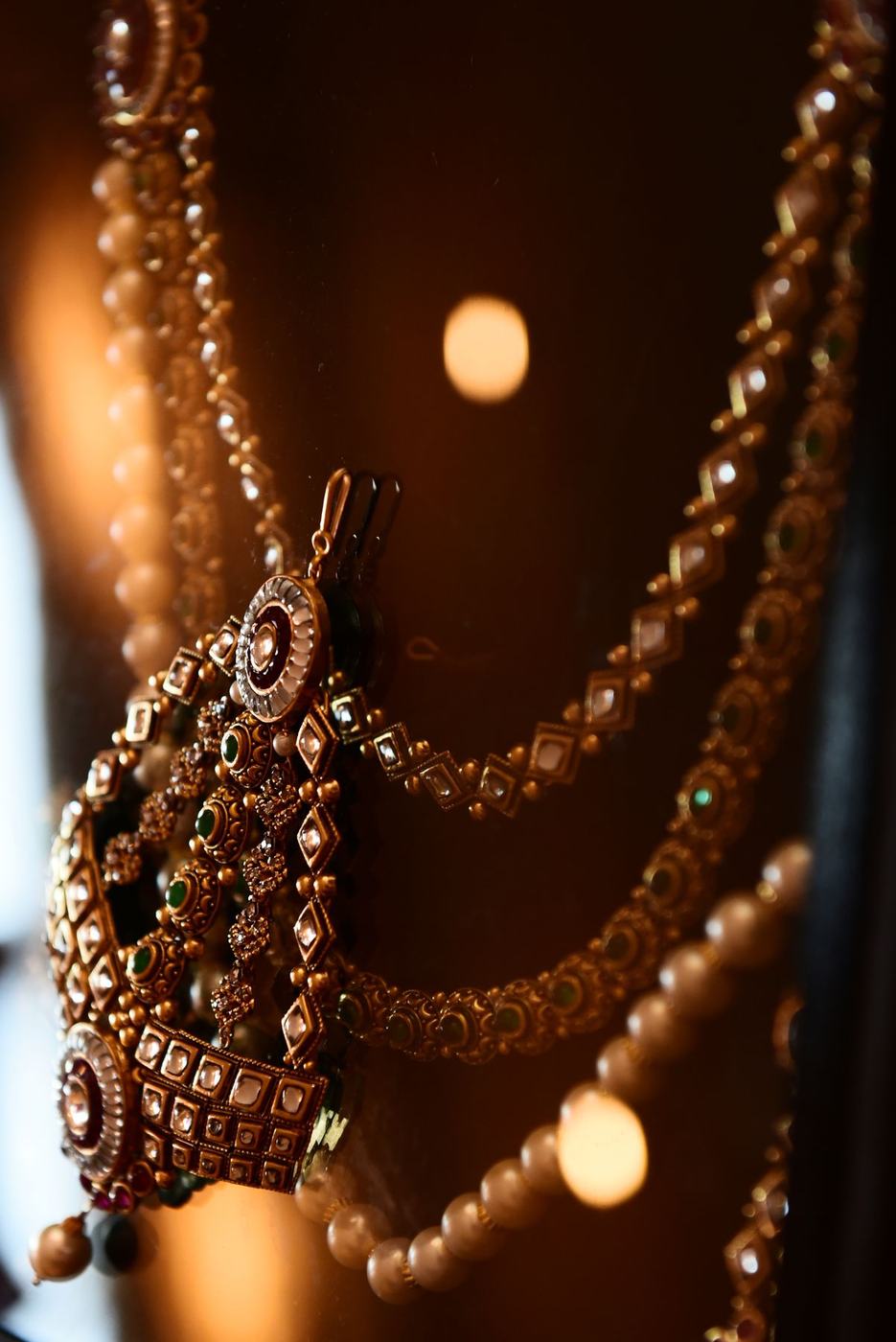 Bridal jewellery hanging in candlelight