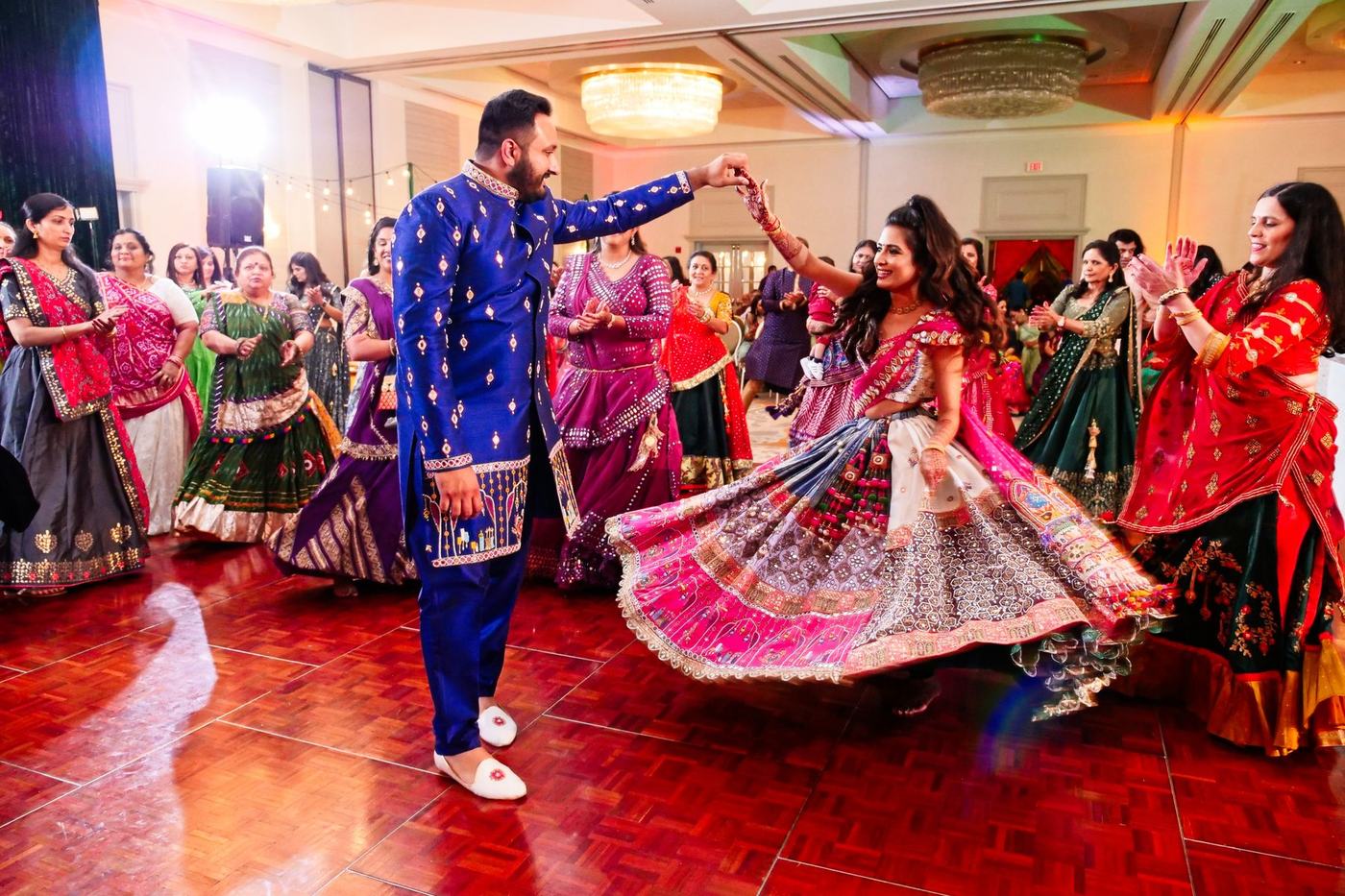 Couple dancing into the crowd at the sangeet
