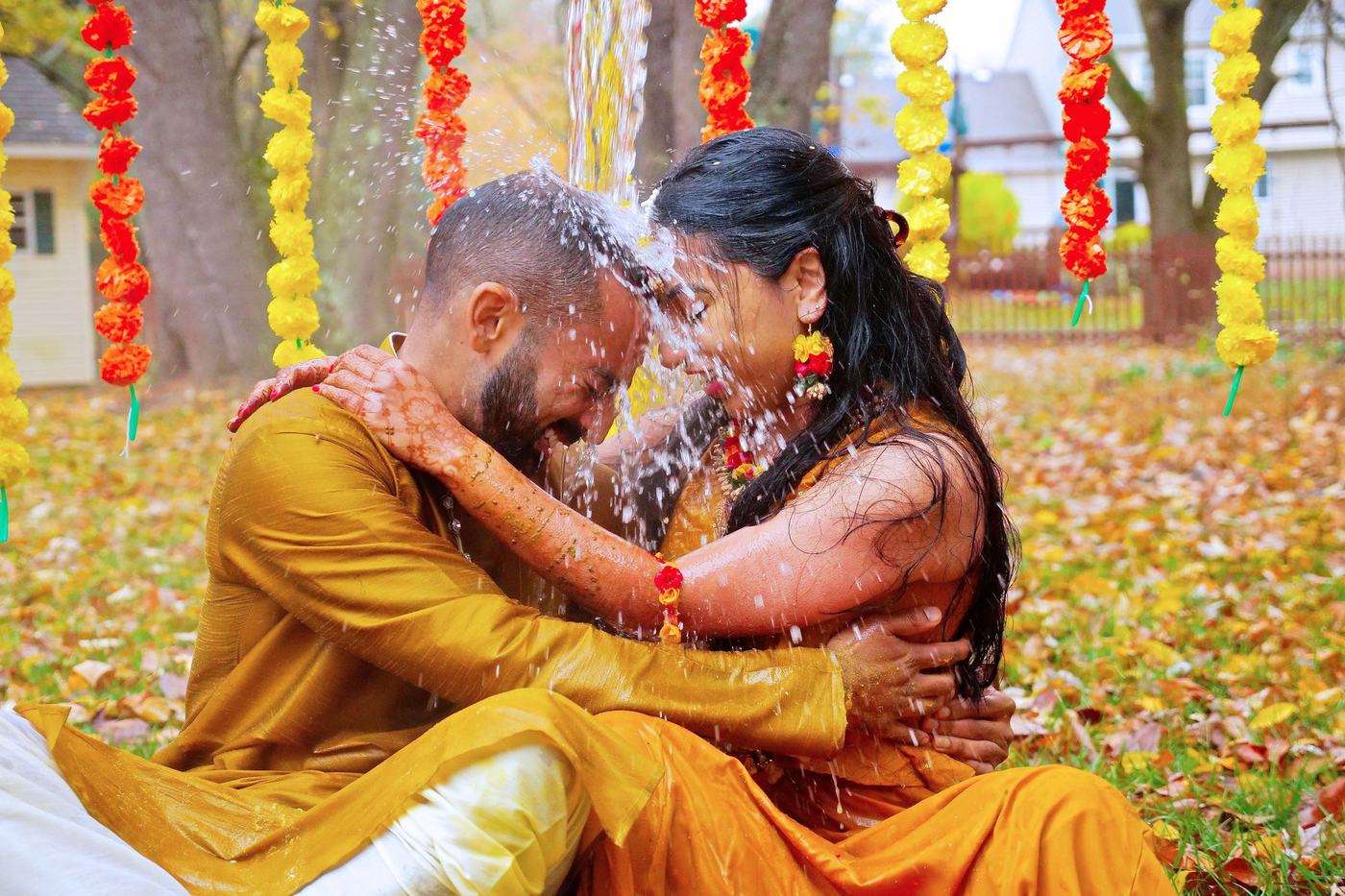 Couple forehead to forehead in yellow at their haldi