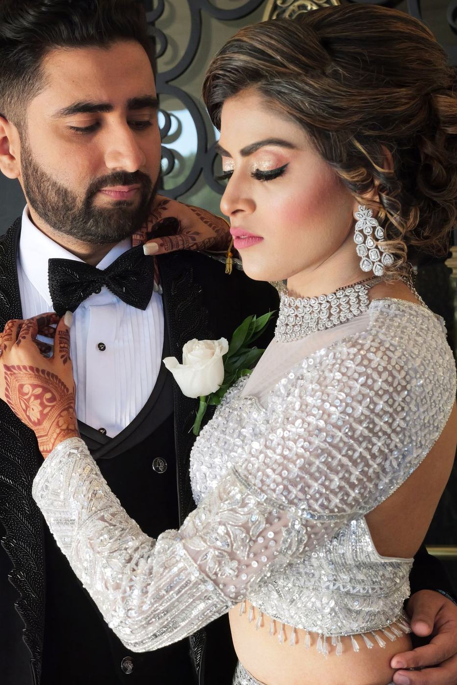 Couple in black tie and silver sequins at the reception