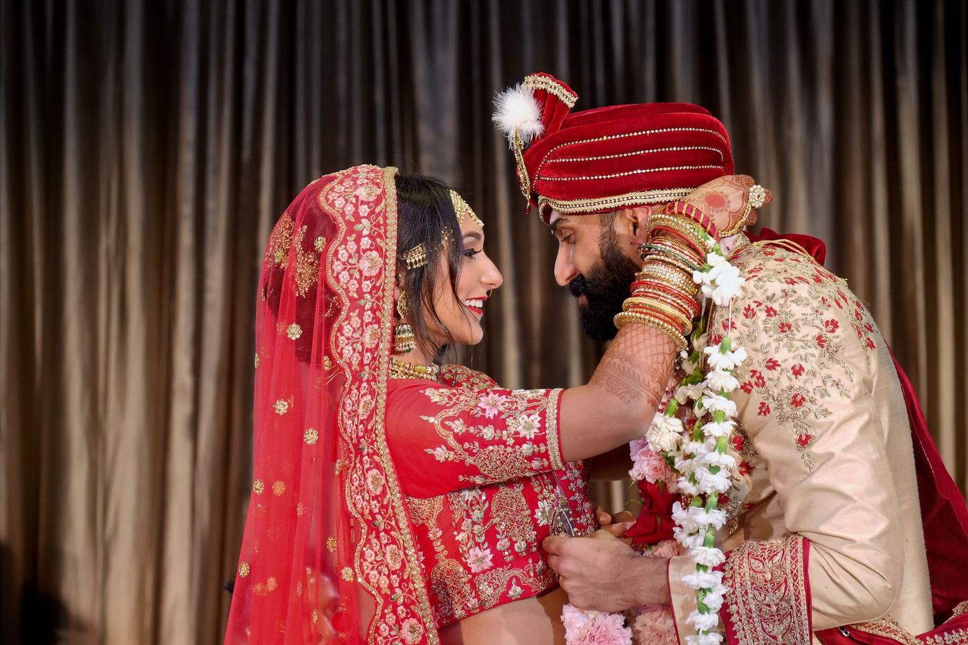 Couple laughing after the garland exchange at Hilton Orlando