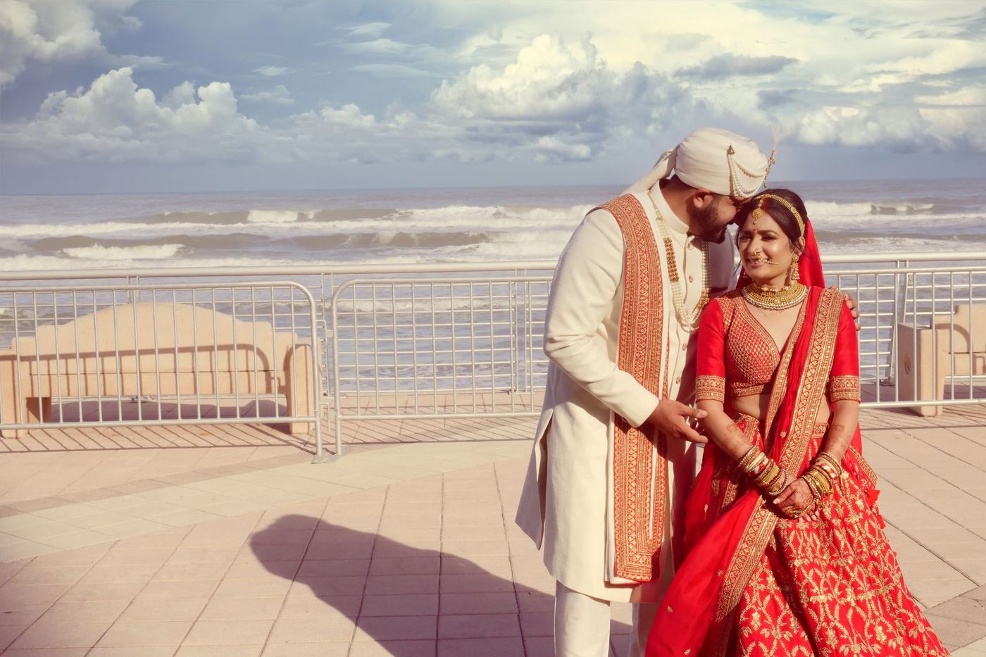 Couple in ivory and red on the beach deck at Daytona