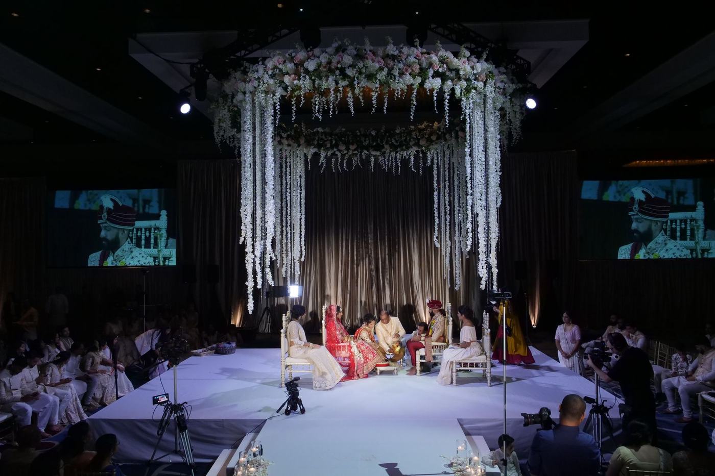 Mandap of white blossom in the Hilton Orlando ballroom